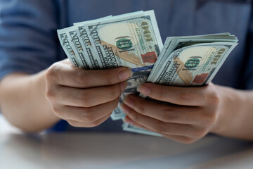 Businesswoman hands counting us dollar banknotes