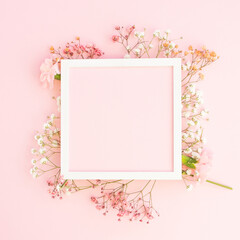 Creative spring greeting card design. Branches of white, and pink  gypsophila and fresh carnations ...