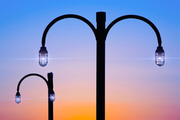 Vintage style street lamps with modern lighting during twilight