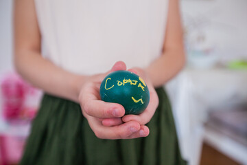 Child hands holding Easter egg at home,closeup view, Holiday day