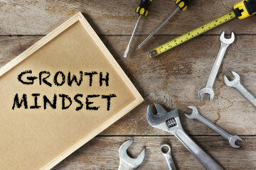 Growth mindset word on frame with tools supplies on wooden background. Success effort with freedom concept and challenge idea - obrazy, fototapety, plakaty