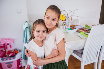 Portrait of two adorable little girls at home, Easter Holiday day