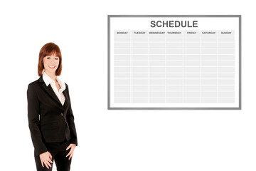 Laughing businesswoman or teacher in front of a schedule, isolated on white background