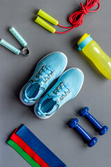 Fototapeta na wymiar Fitness and gym equipment with sneakers and dumbbells. Sport background