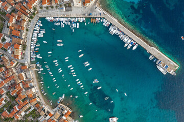 Aerial overhead done shot of Komiza town port on Vis Island in Croatia dusk hour