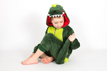 Child in gragon or dinosaur fancy dress isolated on white background.