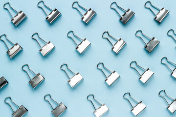 Paper binder clips pattern, copy space. Office supplies background