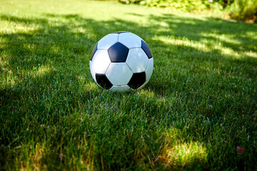 close-up view of leather soccer ball on green grass