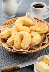 Chipas, typical south american cheese bun in a basket with butter and coffee