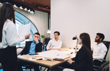 Pensive multiethnic colleagues communicating in workplace