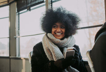 Beautiful girl with afro haircut portraits in the public transport