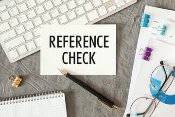REFERENCE CHECK is written in a document on the office desk
