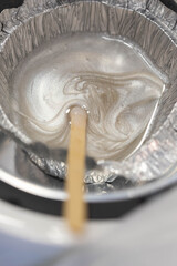 Wax for brow epilation prepare. Hot wax in machine. Professional care for face and brow beauty procedures. 