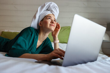 Young woman working at the computer after a shower