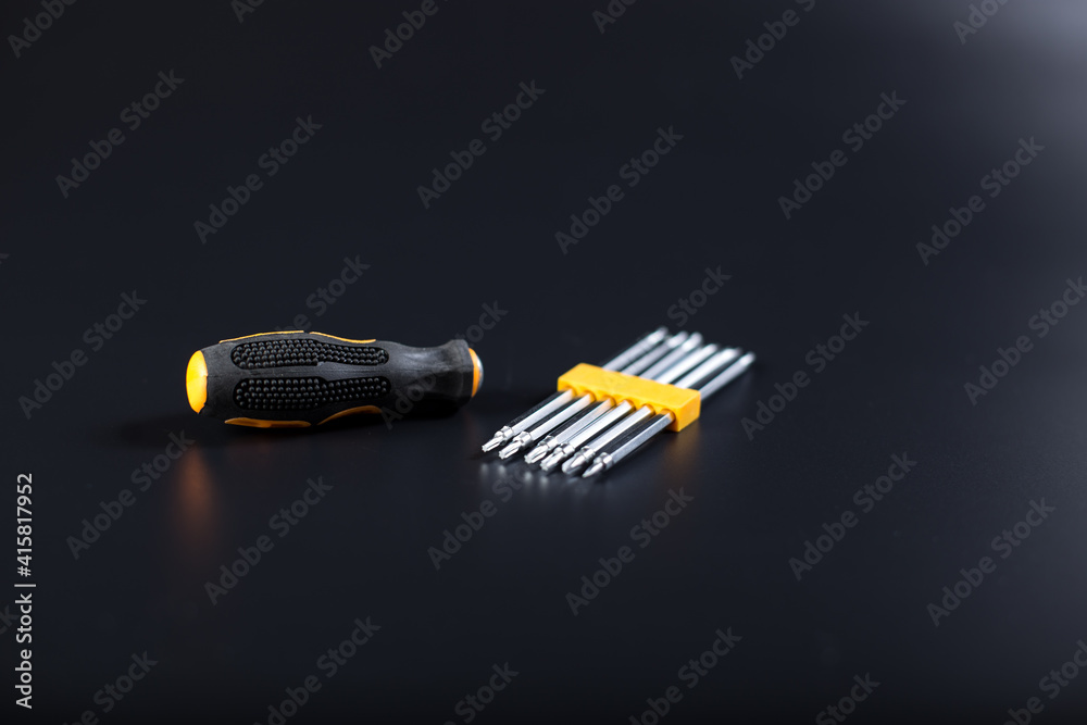 Wall mural Electronics repair screwdriver set. Set of screwdrivers on black with copy space.