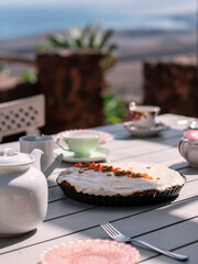 served table with tea pot and vegan bakery for teatime outdoors