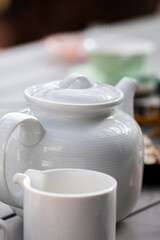 white tea pot and cup served for teatime