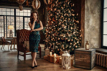 Fototapeta premium Red-haird girl in the background of the Christmas tree in retro style