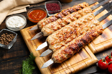 lula kebab with vegetables on cutting board