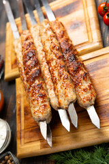 lula kebab with vegetables on cutting board