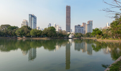 Fototapeta na wymiar Bangkok Skyline with reflection on the lake