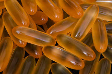 pile of omega 3 and vitamin d capsules