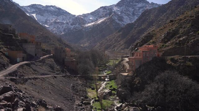 Lush valley and snow capped Toubkal mountains in background, Imlil, High Atlas