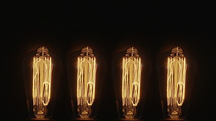 Cztery żarówki Edisona na czarnym tle 