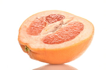 Ripe natural half of a grapefruit, close-up, isolated on white.