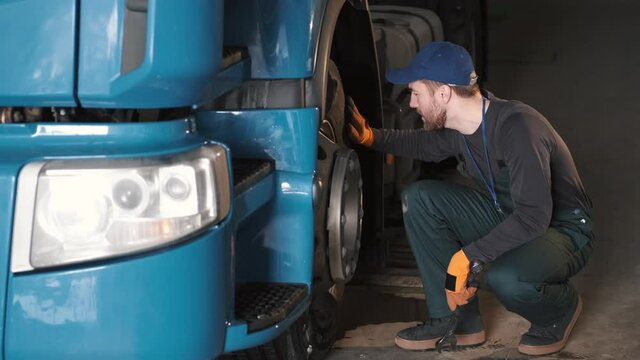 a mechanic is doing a checkup and fixing the truck for it to run