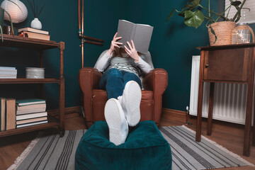 Woman reading book at home
