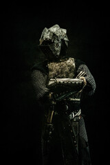 Portrait of a medieval fighter in armor with his arms crossed - obrazy, fototapety, plakaty