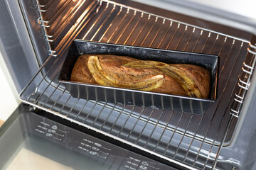 freshly baked vegan banana bread in open oven. Homemade baking. soft focus