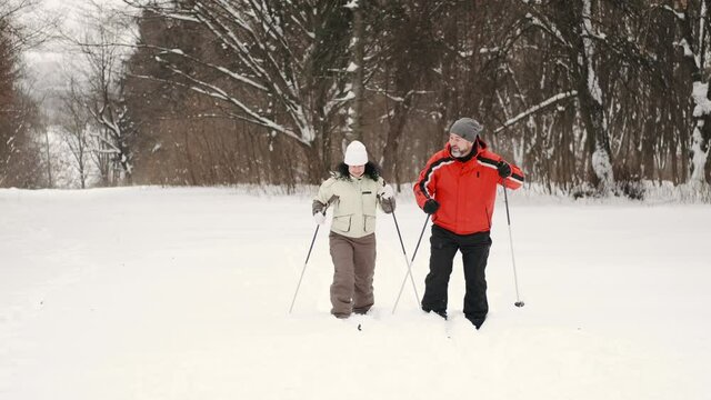 couples playing in the snow and snowshoeing