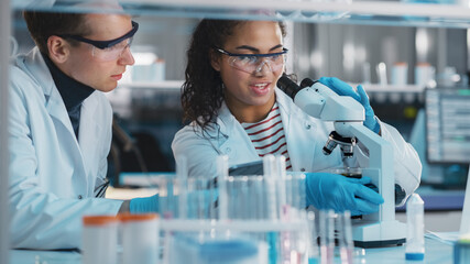 Modern Medical Research Laboratory: Portrait of Black and Caucasian Young Scientists Using...