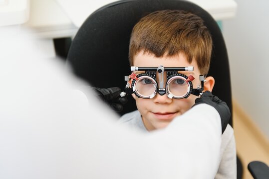 Trial frame. Glasses for a little boy. Hypermetropia. Ametropia correction with glasses.