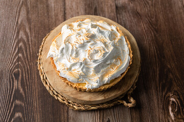 Lemon pie on top of log and wooden table. zenithal view