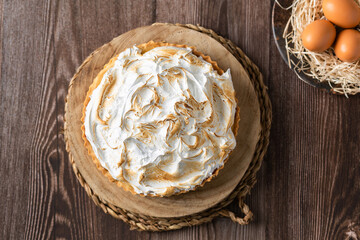 Lemon pie on top of log and wooden table. zenithal view