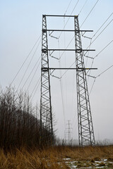 power line over agriculture fields a foggy morning