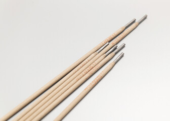 scattered welding electrodes, a pile, on a light background