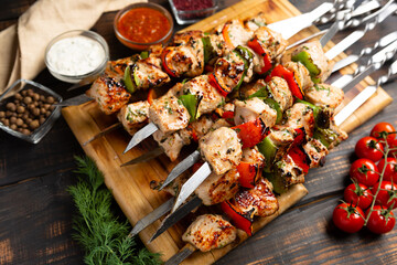 shish kebab with pepper tomatoes and onion on rustic wooden table background