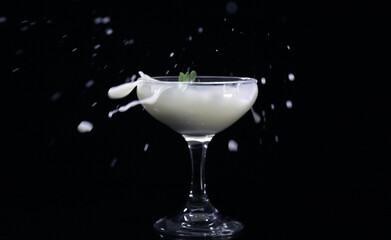 Splash drink into the glass with black background