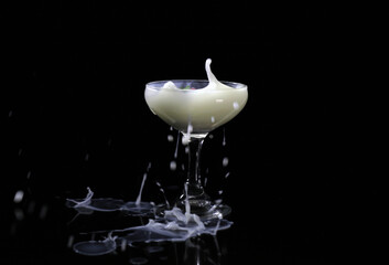 Spash drink into the glass with black background