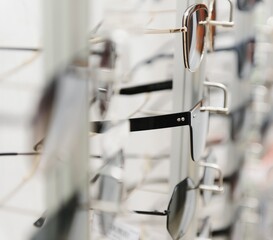 rack with glasses and sunglasses close up