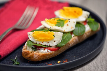 Meal with boiled eggs, toast, yogurt and spinach