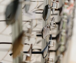 rack with glasses and sunglasses close up