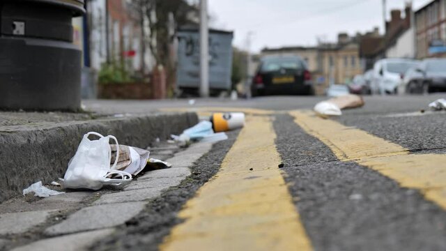 Medical face mask and other litter in the street during the Coronavirus pandemic, UK