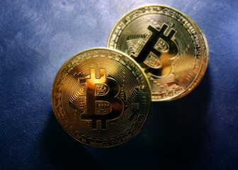 Gold bitcoin vitual cryptocurrency on blue