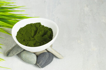 Chlorella algae powder on a light background. A green superfood for a vegetarian diet. Chalk lettering. Healthy lifestyle concept. SPA procedures. Top view. Copy space