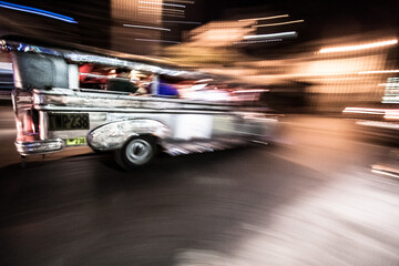 the iconic Philippine jeepney, the king of the road in Metro manila. Jeepney speeding in the...